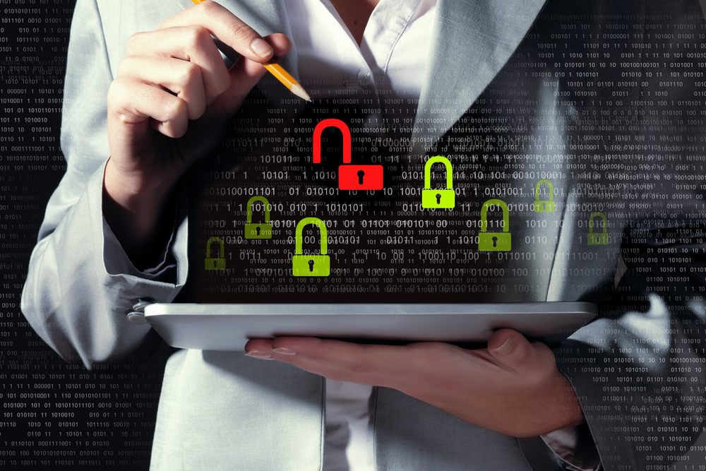 Businesswoman holding tablet pc entering password_ Security concept-1