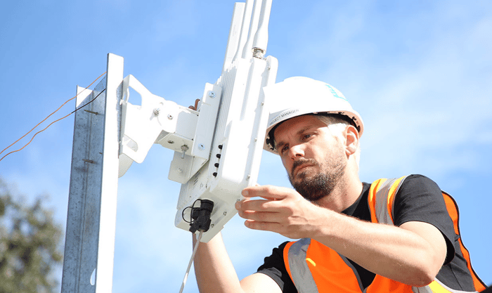 Technician installing Cradlepoint on roof.jpg