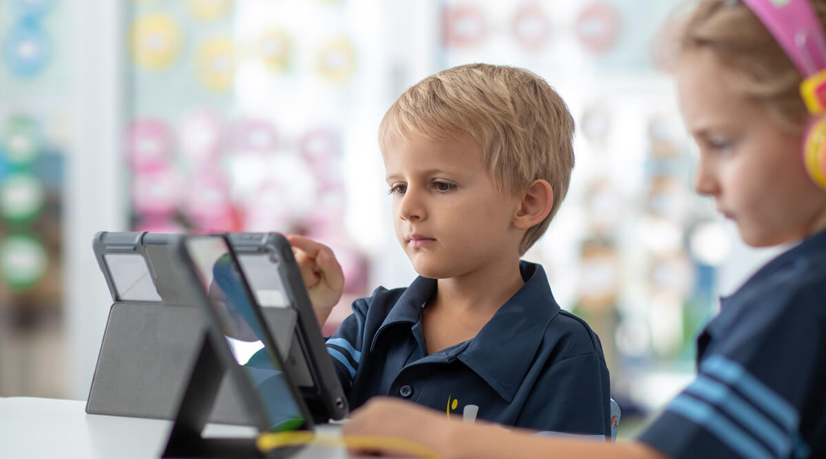 education - blond primary boy with tablet