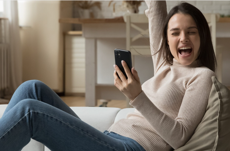 Woman with phone celebrating-1