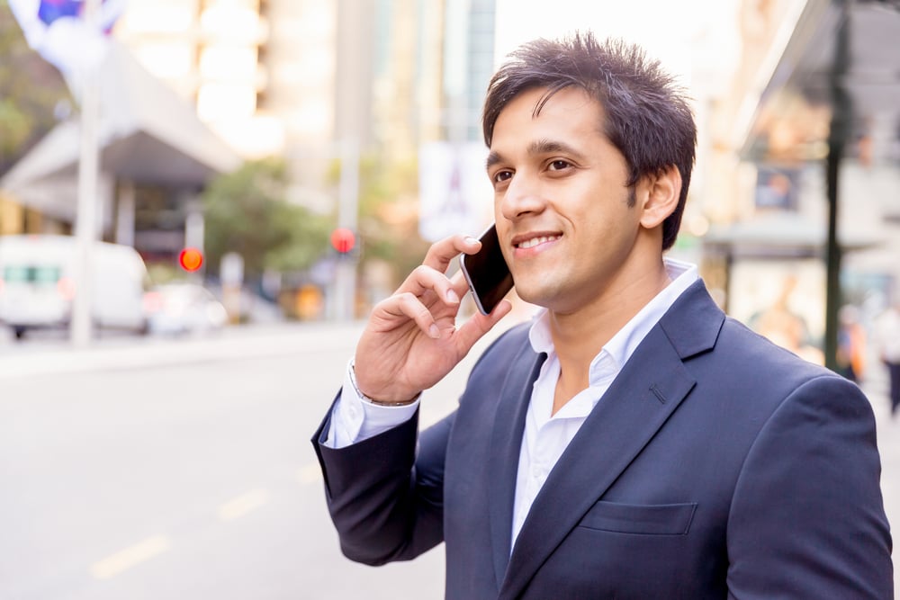 Portrait of confident businessman with his mobile phone outdoors