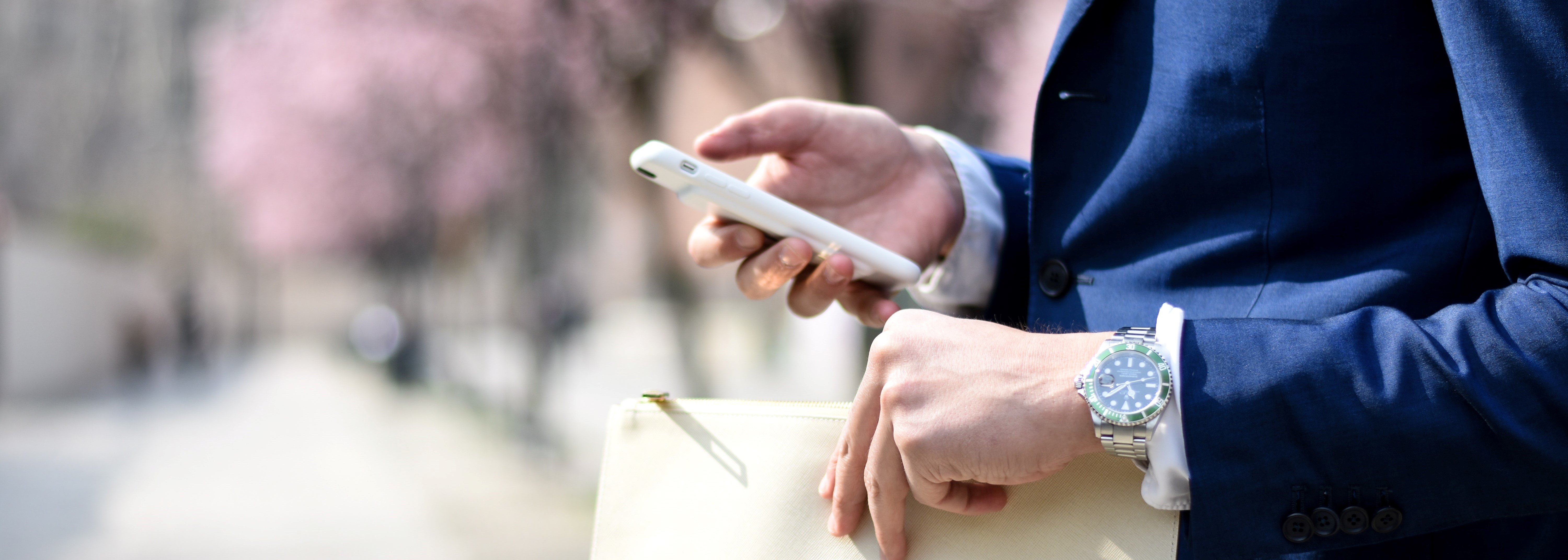 business suit holding phone 