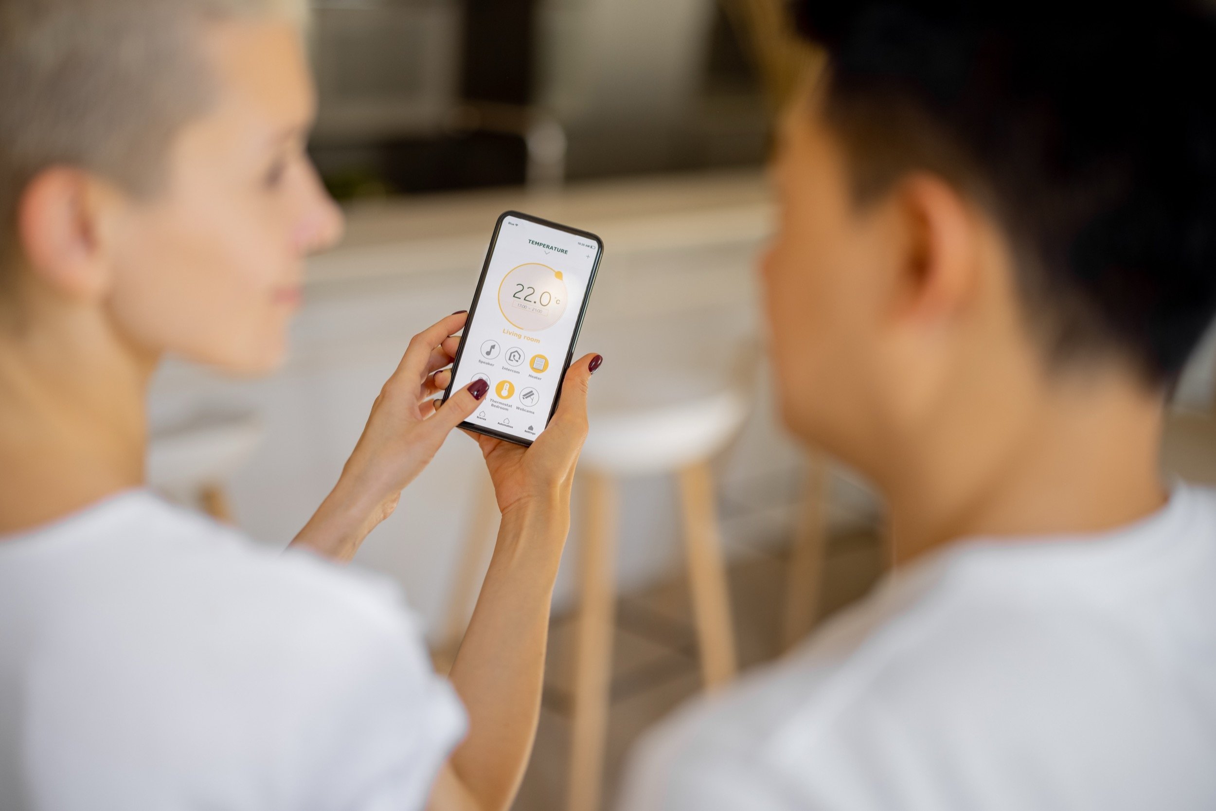 couple-using-app-of-smart-home-on-smartphone-2025-03-13-03-31-38-utc