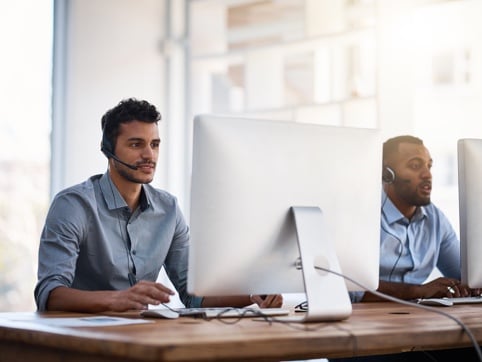 men on apple pcs with headset customer service