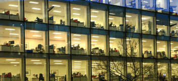 people working in office building at night